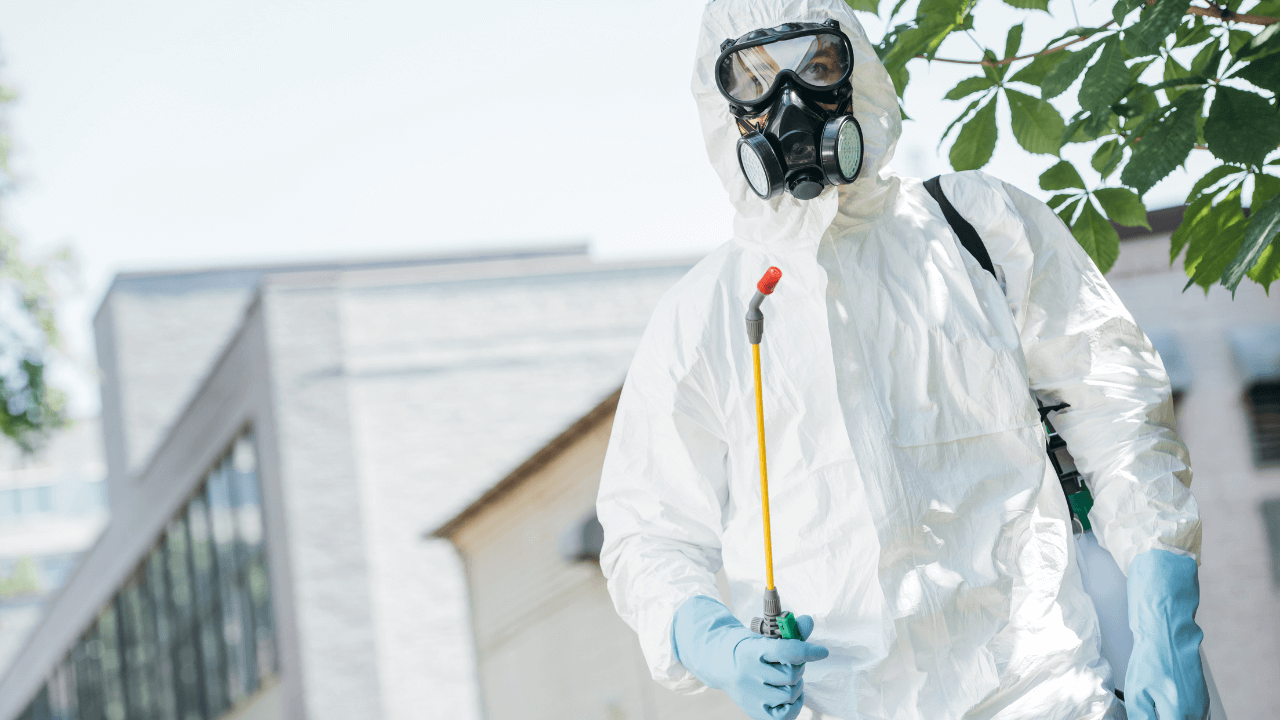 low angle view of a pest control worker standing and holding a sprayer