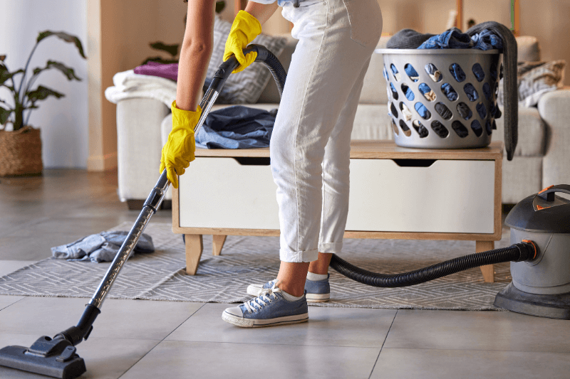 woman vacuum untidy home living room