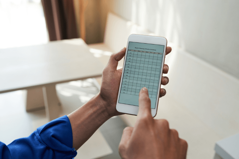 checking room cleaning schedule on the phone
