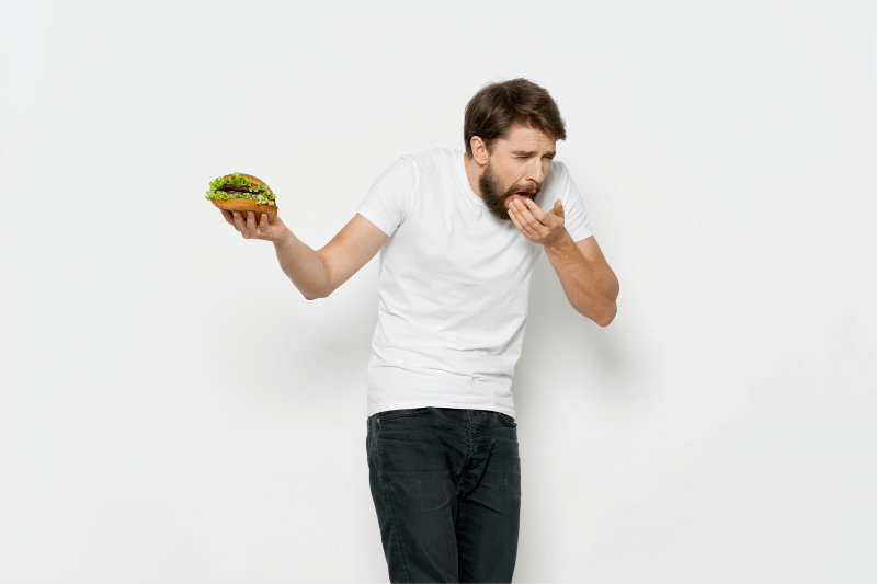 a man eating a pest-contaminated burger