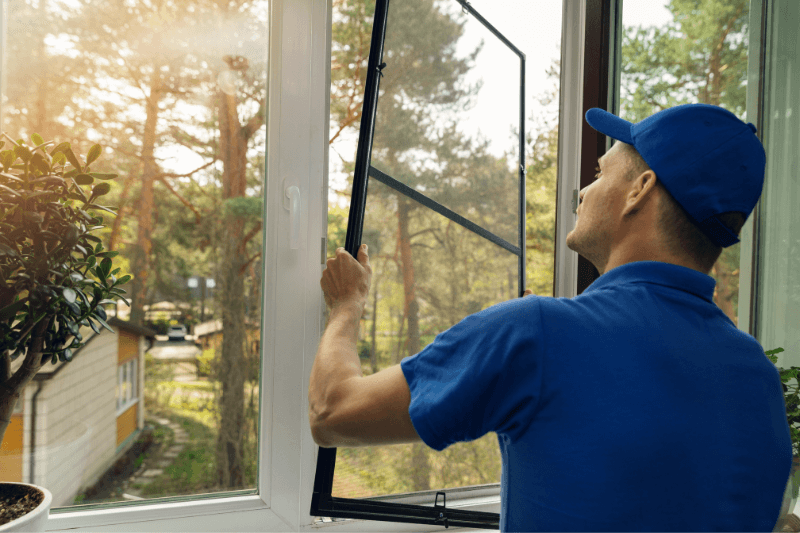 worker installing mosquito net wire