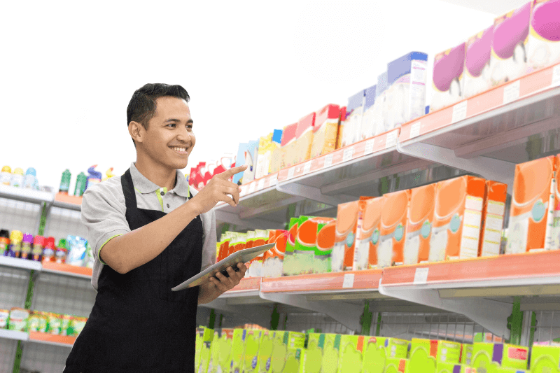 happy young supermarket owner doing product inventory