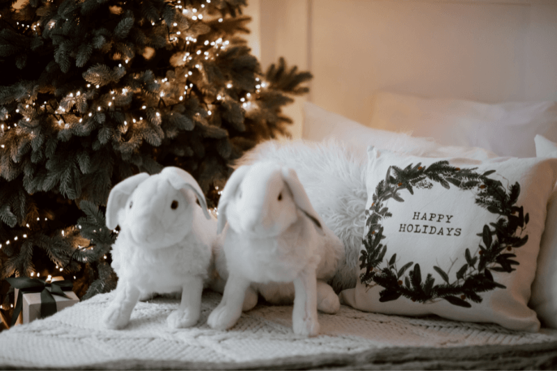 a guest room with two stuffed animals next to a tree 