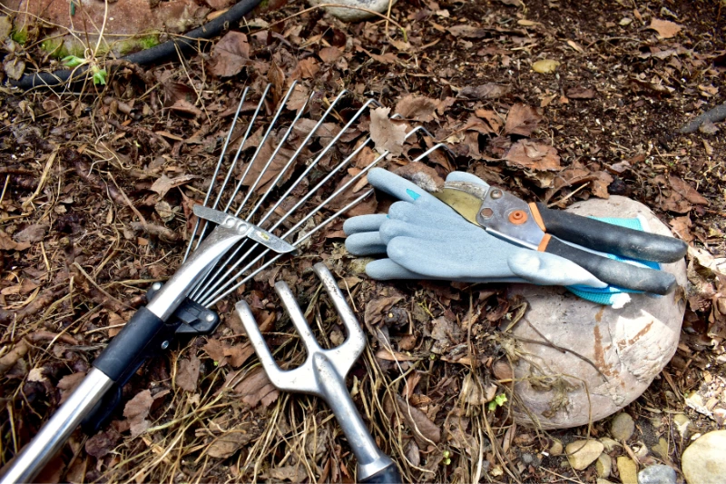 Start the Year Right: Your Easy Guide to a New Year 2024_Yard clean up after winter, clearing up<br />
mulch and garden debris for seasonal<br />
growth. Photo background,<br />
landscaping work. Lifestyle hobbies