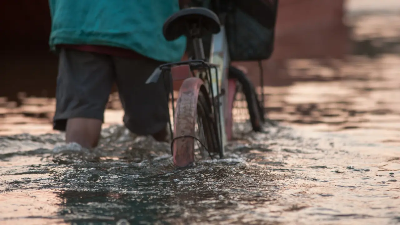 a biker in a flooded road