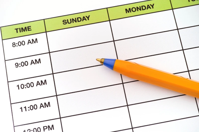 A pencil is positioned on a weekly planner, representing the organization of home maintenance activities for the week ahead.