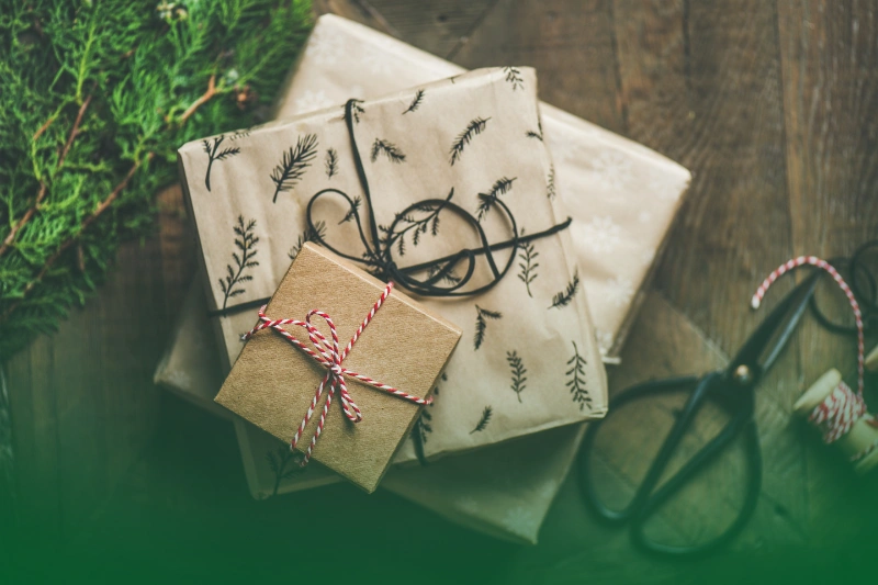 a bag with presents and a branch