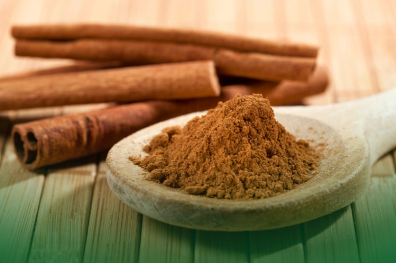 Cinnamon Magic cinnamon, whole sticks behind a wooden spoon with a heap of powder - Natural Ways To Get Rid of Ants