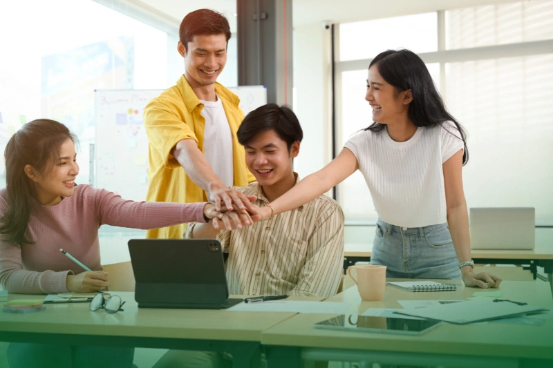 Enhancing Employee Productivity and Morale teamwork business concept, happy Asian people in a workplace