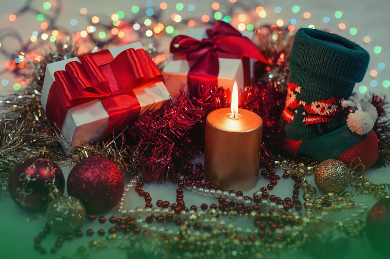 Holiday Decorations a candle and presents with lights for ber months home tips
